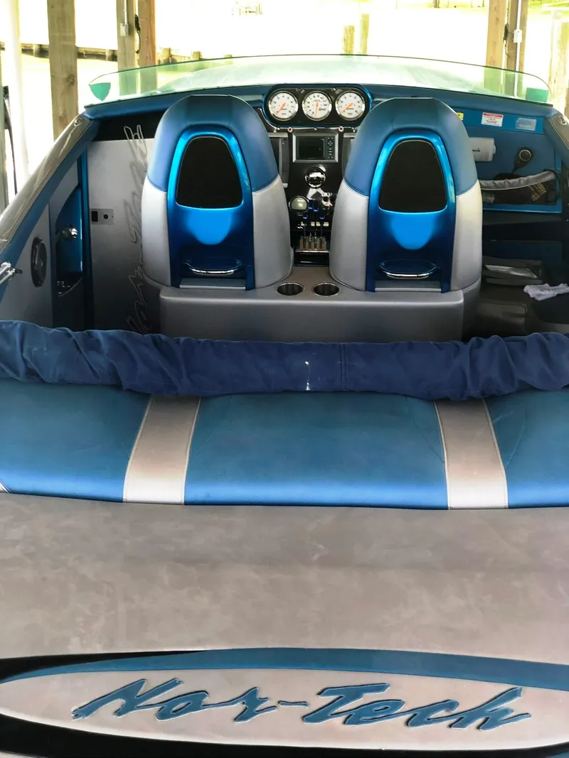 Slide: The Image of 2013 Nor-Tech 477 SPX Vee Bottom boat interior with blue seats and dashboard. - 23