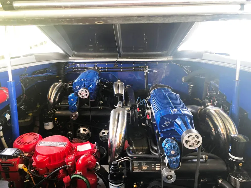 Slide: The Image of Engine compartment of 2013 Nor-Tech 477 SPX Vee Bottom with dual blue superchargers. - 29