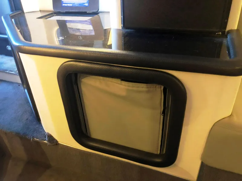 Slide: The Image of 2013 Nor-Tech 477 SPX Vee Bottom interior detail with sleek black trim and storage compartment. - 38