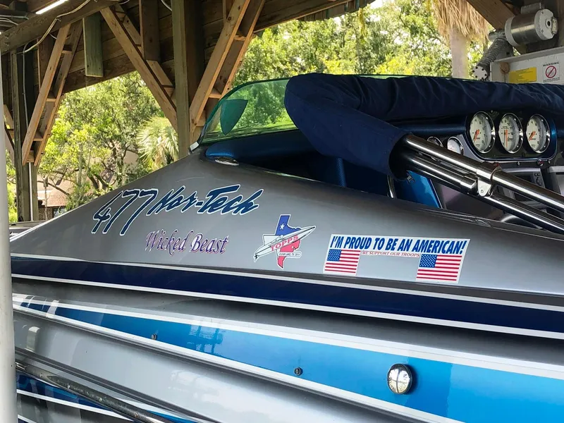 Slide: The Image of 2013 Nor-Tech 477 SPX Vee Bottom boat with patriotic decals and "Wicked Beast" text. - 42