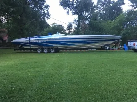Slide: The Image of 2013 Nor-Tech 477 SPX Vee Bottom boat on trailer, parked on grassy area. - 6
