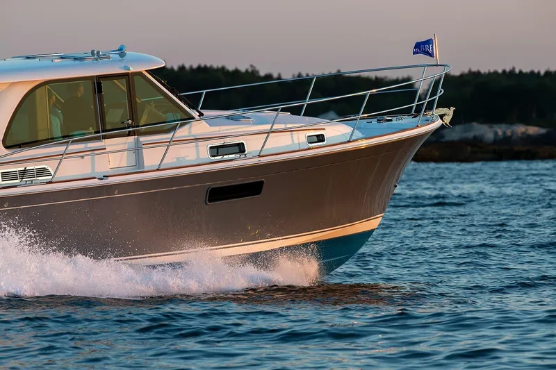 Slide: The Image of 2026 Sabre 43 Salon Express cruising on water at sunset. - 4