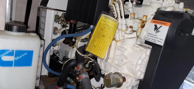 Slide: The Image of Engine compartment of a 2005 Sea Ray 390 Motor Yacht, featuring mechanical components and warning labels. - 11