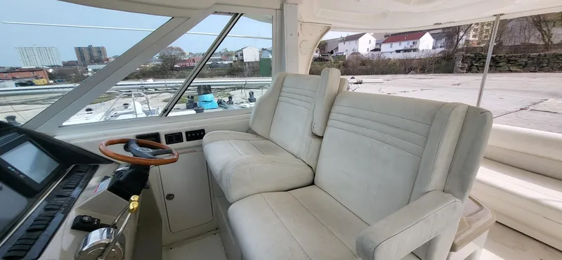Slide: The Image of 2005 Sea Ray 390 Motor Yacht interior with plush seating and modern helm controls. - 15