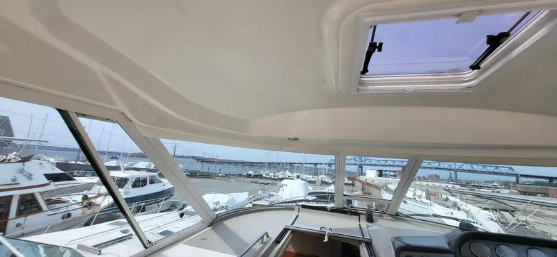 Slide: The Image of 2005 Sea Ray 390 Motor Yacht interior view with marina and bridge in background. - 18