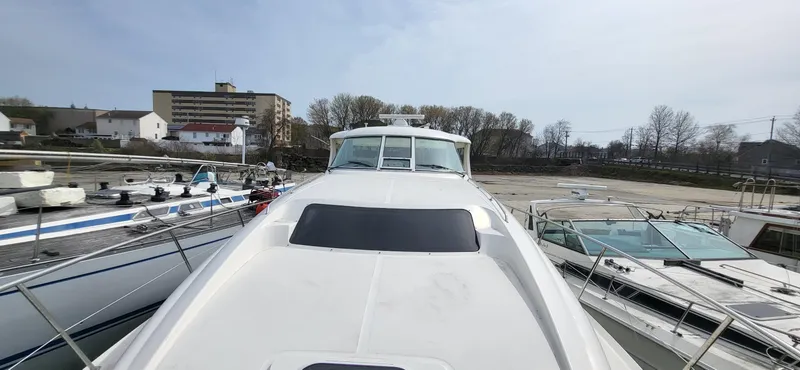 Slide: The Image of 2005 Sea Ray 390 Motor Yacht docked, surrounded by other boats, with buildings in the background. - 21
