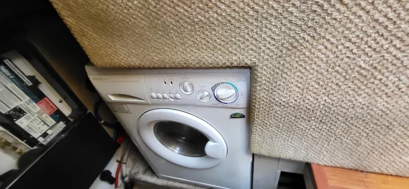 Slide: The Image of Washing machine in a 2005 Sea Ray 390 Motor Yacht interior, next to electrical panel. - 23