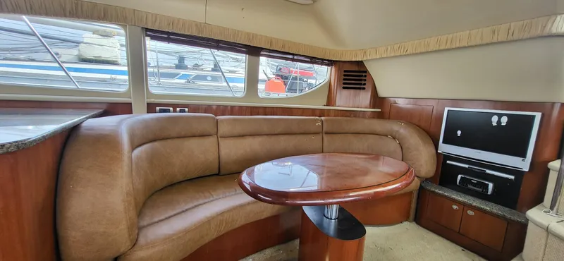 Slide: The Image of Interior of 2005 Sea Ray 390 Motor Yacht with leather seating and TV. - 24