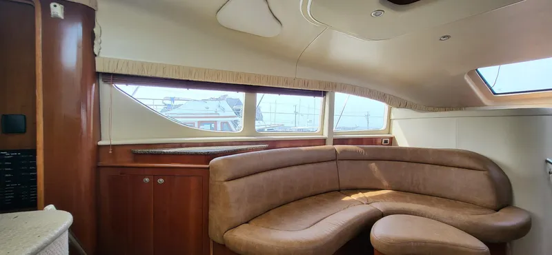 Slide: The Image of Luxurious 2005 Sea Ray 390 Motor Yacht interior with elegant leather seating and panoramic windows. - 26