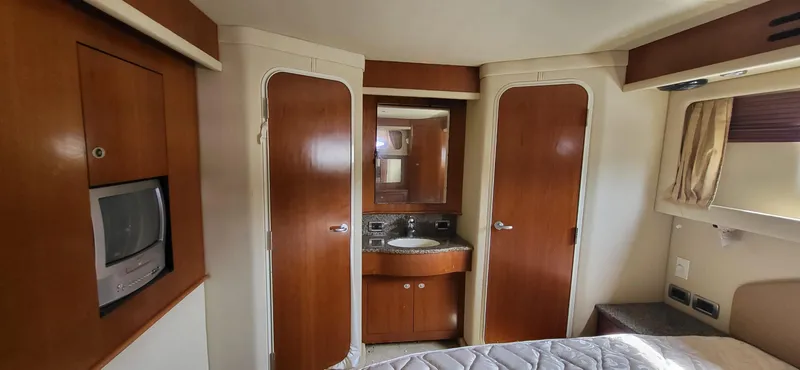 Slide: The Image of Interior of 2005 Sea Ray 390 Motor Yacht with wood finishes and compact amenities. - 27