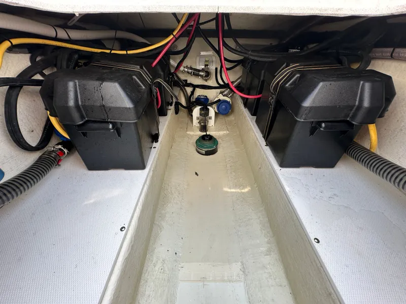 Slide: The Image of 2023 Edgewater 285CC boat interior showing battery compartments and wiring setup. - 22