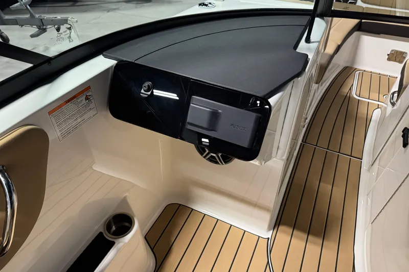 Slide: The Image of 2026 Sea Ray SDX 270 Surf boat interior with sleek dashboard and wood-style flooring. - 14