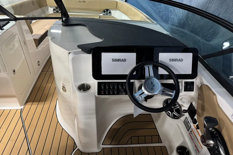 Slide: The Image of 2026 Sea Ray SDX 270 Surf boat dashboard with Simrad displays and modern steering wheel. - 15