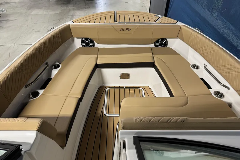 Slide: The Image of 2026 Sea Ray SDX 270 Surf boat interior with tan seating and wood accents. - 18