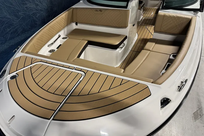 Slide: The Image of 2026 Sea Ray SDX 270 Surf boat interior with tan seating and sleek design. - 19