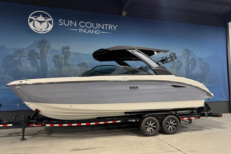 Slide: The Image of 2026 Sea Ray SDX 270 Surf boat on trailer at Sun Country Inland showroom. - 2
