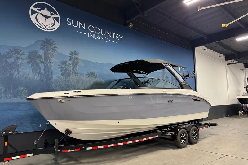Slide: The Image of 2026 Sea Ray SDX 270 Surf boat displayed indoors at Sun Country Inland. - 3