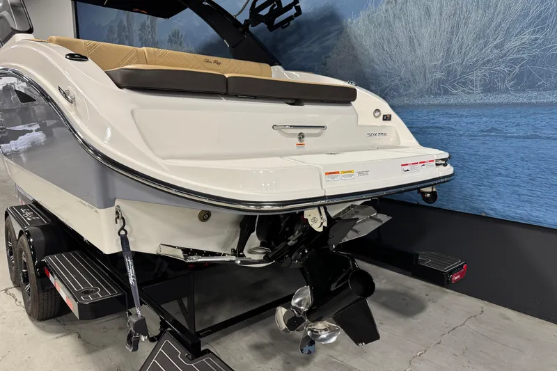 Slide: The Image of 2026 Sea Ray SDX 270 Surf boat on trailer, rear view, in showroom setting. - 5