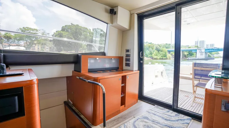 Slide: The Image of Interior view of 2015 Prestige 550 Flybridge yacht with modern design and outdoor access. - 12