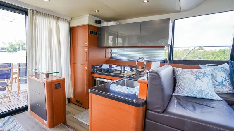 Slide: The Image of Luxurious interior of 2015 Prestige 550 Flybridge yacht with modern kitchen and seating area. - 13