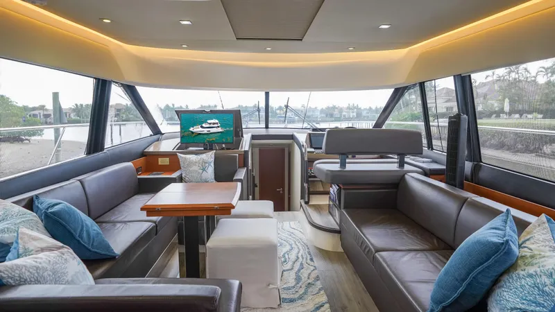 Slide: The Image of Luxurious interior of a 2015 Prestige 550 Flybridge yacht with leather seating and modern decor. - 16