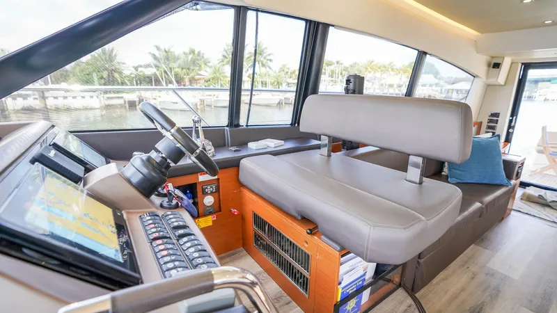 Slide: The Image of Interior of 2015 Prestige 550 Flybridge yacht with helm station and seating. - 19