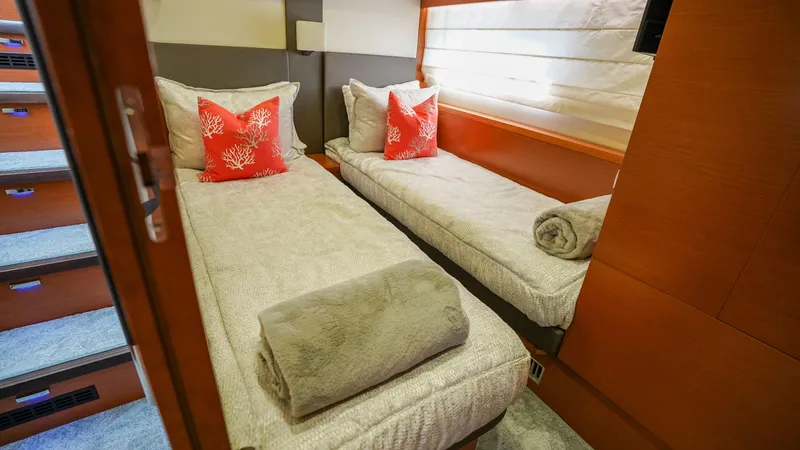 Slide: The Image of Luxurious twin cabin in 2015 Prestige 550 Flybridge yacht with coral-themed decor. - 26
