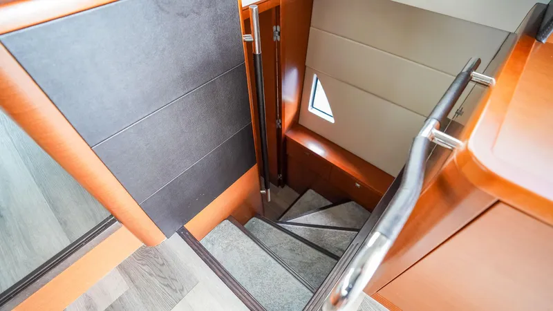 Slide: The Image of Staircase inside 2015 Prestige 550 Flybridge yacht with modern wood and metal design. - 29