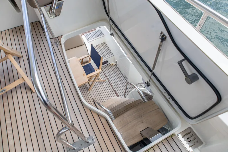 Slide: The Image of Stairway view on 2015 Prestige 550 Flybridge yacht with wooden deck and seating area. - 35