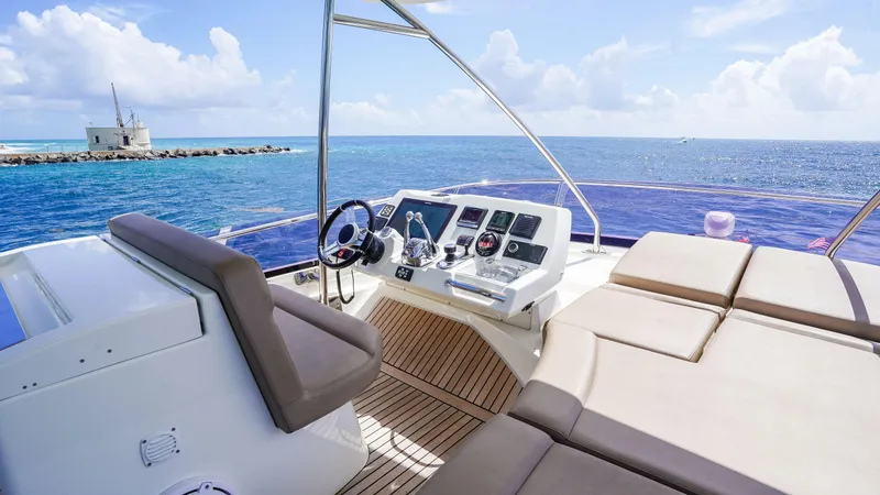 Slide: The Image of Flybridge of 2015 Prestige 550 yacht with ocean view and luxurious seating. - 41