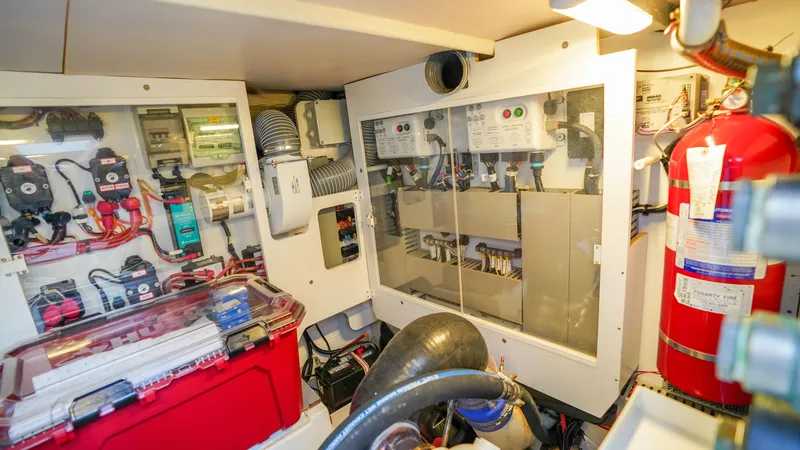 Slide: The Image of Engine room of 2015 Prestige 550 Flybridge yacht with electrical panels and fire extinguisher. - 49