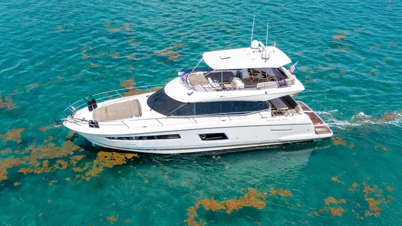 Slide: The Image of 2015 Prestige 550 Flybridge yacht cruising in clear turquoise waters. - 5