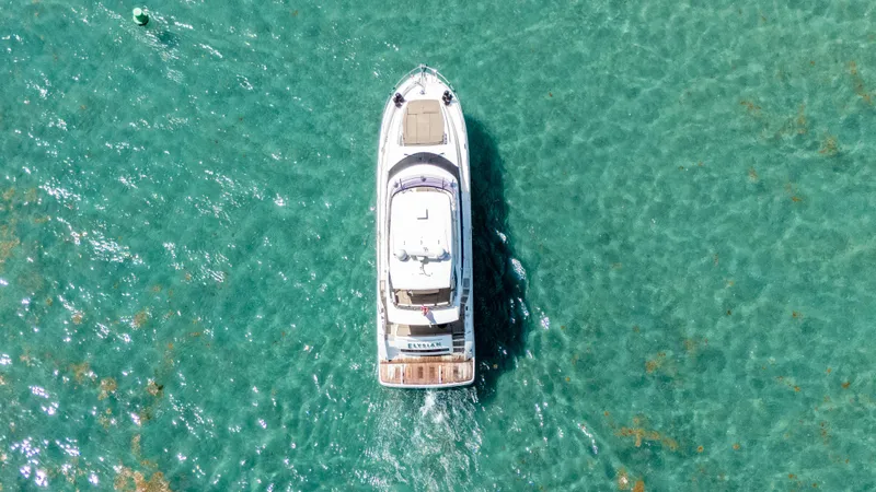 Slide: The Image of Aerial view of 2015 Prestige 550 Flybridge yacht on turquoise water. - 7