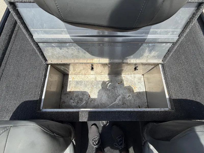 Slide: The Image of 2020 Bass Tracker Classic XL boat storage compartment, open and empty, with shadow and seat view. - 12