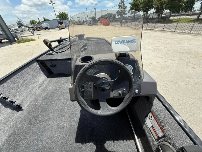 Slide: The Image of 2020 Bass Tracker Classic XL boat dashboard with steering wheel and Lowrance fish finder. - 11