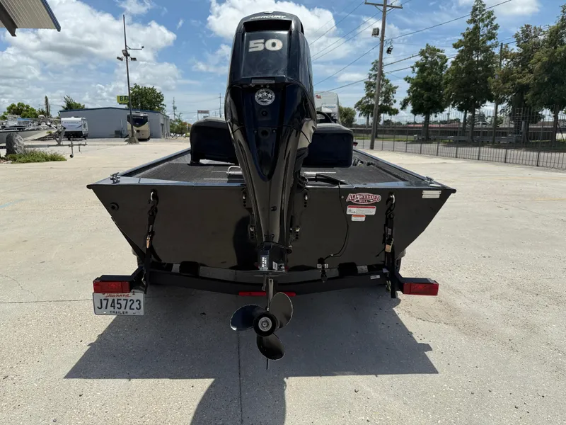 Slide: The Image of 2020 Bass Tracker Classic XL boat with a 50 HP engine, parked outdoors. - 6
