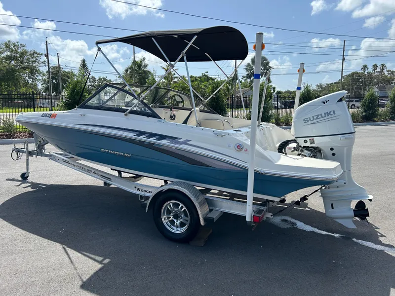 Slide: The Image of 2021 Stingray 191 DC boat with Suzuki outboard motor on a trailer. - 3