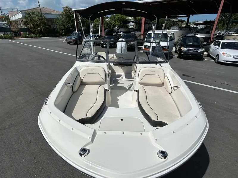 Slide: The Image of 2021 Stingray 191 DC boat with spacious seating, parked outdoors. - 5