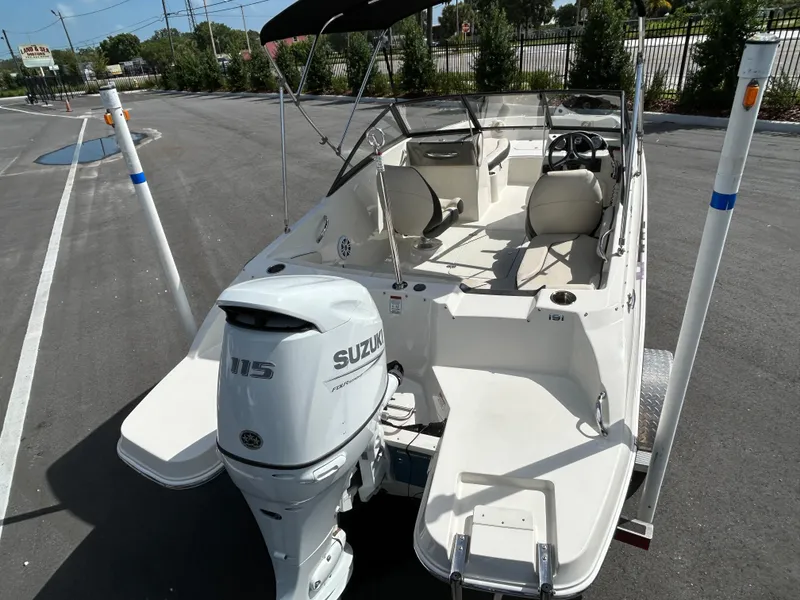 Slide: The Image of 2021 Stingray 191 DC boat with Suzuki 115 outboard motor, parked on a sunny day. - 6