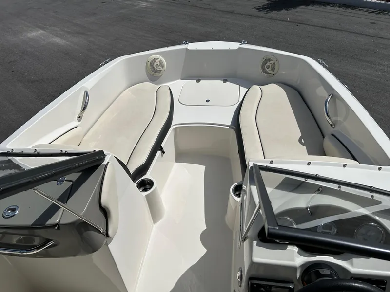 Slide: The Image of 2021 Stingray 191 DC boat interior with cushioned seating and steering console. - 7