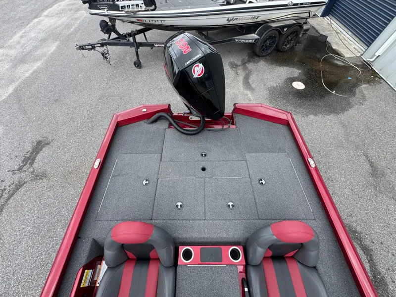 Slide: The Image of 2022 Vexus AVX2080 boat with Mercury engine, red and gray interior, parked on pavement. - 10