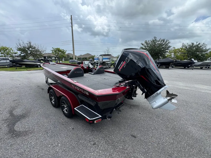 Slide: The Image of 2022 Vexus AVX2080 boat with powerful outboard motor, parked on a paved lot. - 19
