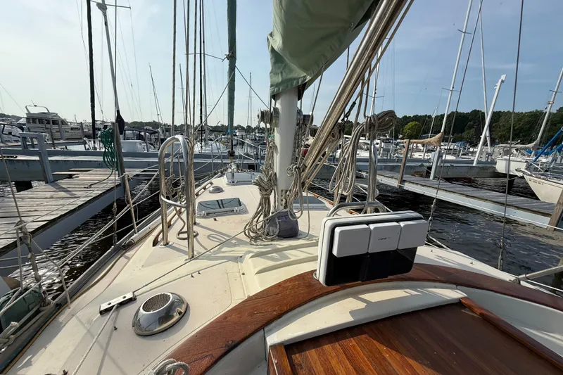 Slide: The Image of 1979 Gulfstar 43 MK II sailboat docked at marina, showcasing deck and rigging. - 10