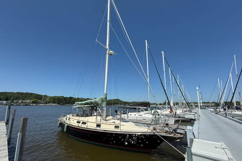 Slide: The Image of 1979 Gulfstar 43 MK II sailboat docked at marina under clear blue sky. - 2