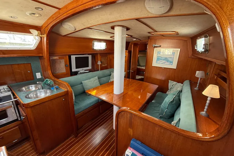 Slide: The Image of 1979 Gulfstar 43 MK II yacht interior with wood finish, cozy seating, and modern amenities. - 23