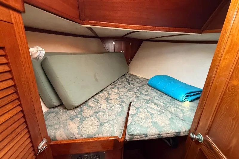 Slide: The Image of Cozy cabin interior of 1979 Gulfstar 43 MK II sailboat with patterned bedding. - 28