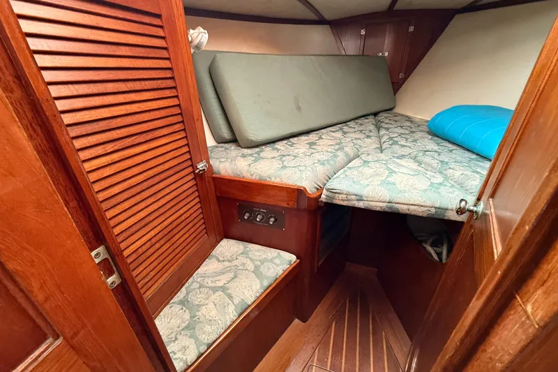Slide: The Image of 1979 Gulfstar 43 MK II cabin interior with wooden finish and cushioned seating. - 29