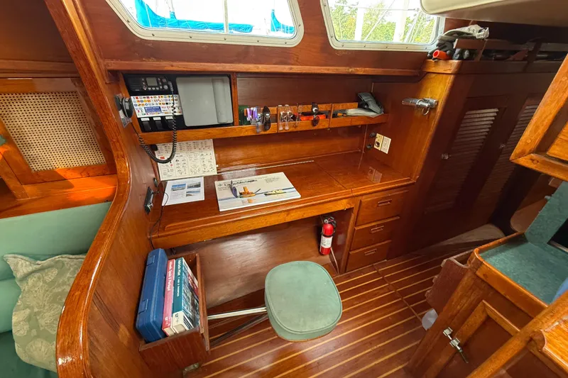 Slide: The Image of 1979 Gulfstar 43 MK II yacht interior with navigation station and wooden cabinetry. - 32