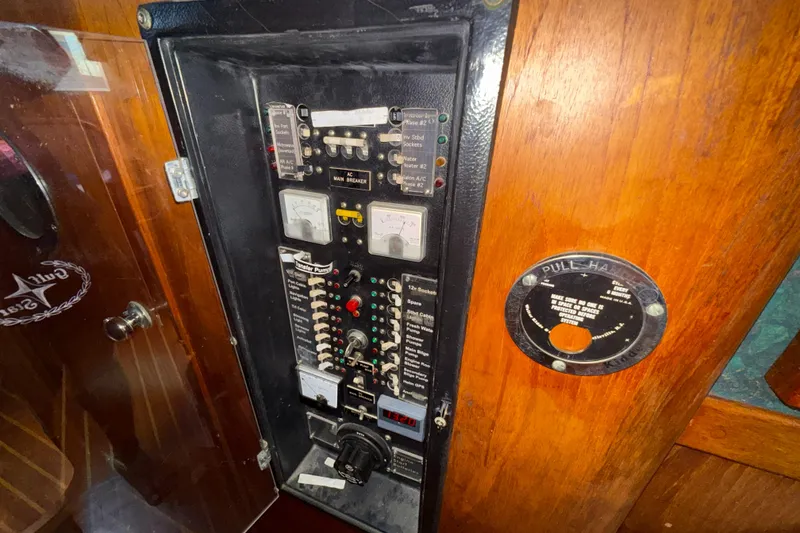 Slide: The Image of Electrical panel on a 1979 Gulfstar 43 MK II yacht, featuring various switches and gauges. - 34