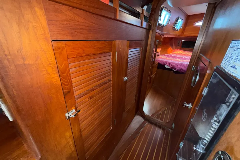 Slide: The Image of 1979 Gulfstar 43 MK II yacht interior with wooden cabinetry and cozy sleeping area. - 36